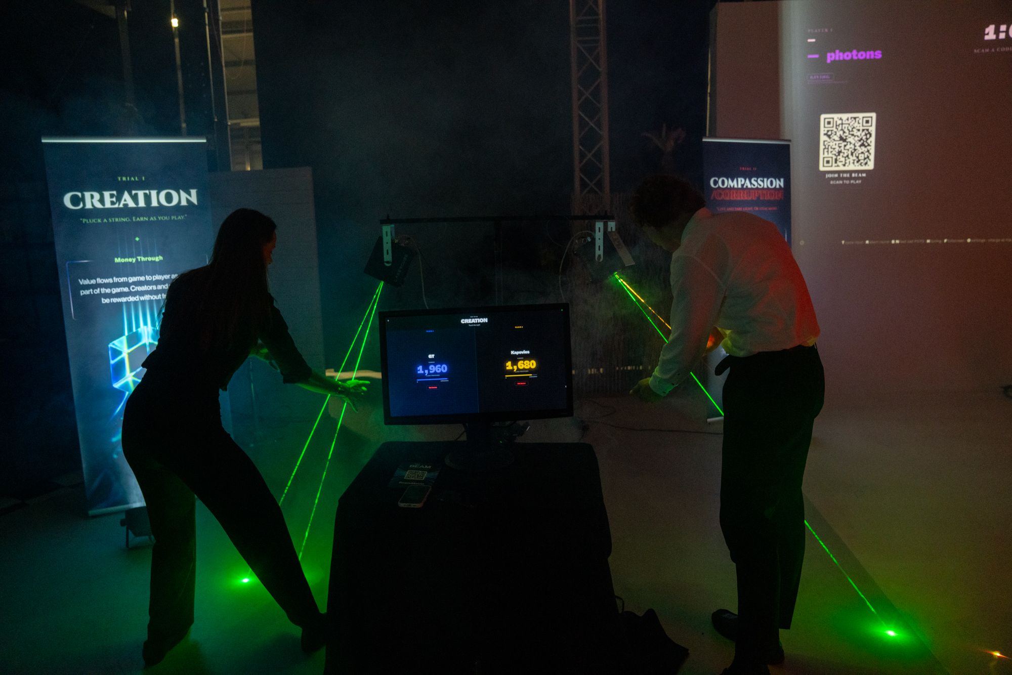 Two people playing the BEAM installation